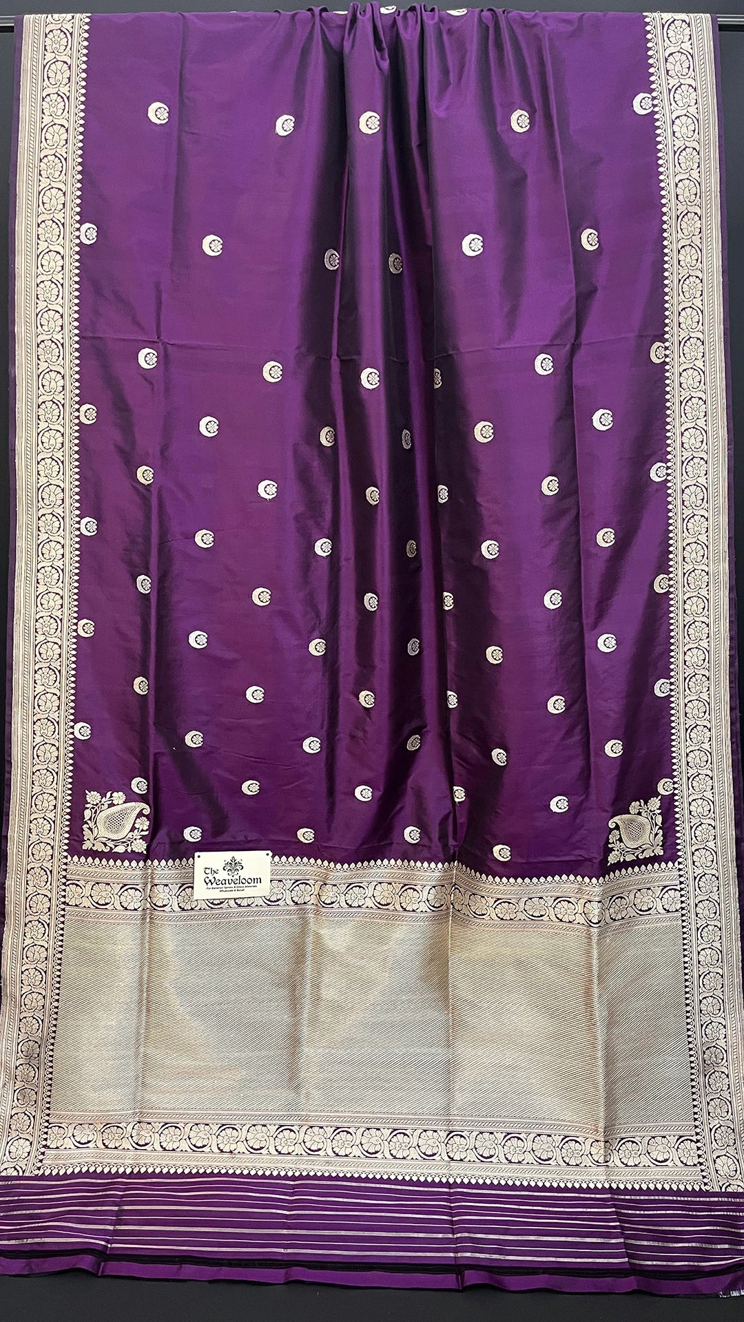 Shop magenta pure Katan silk handloom Banarasi saree with Chand Tara motifs and elegant zari border. A luxurious choice for weddings.