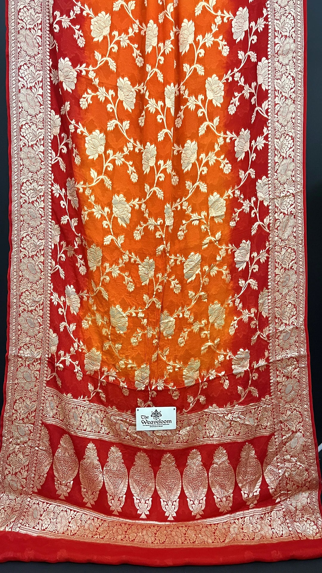 The Weaveloom Rust Orange & Red Pure Crepe Georgette Banarasi Saree with Golden Zari Floral Jaal Work